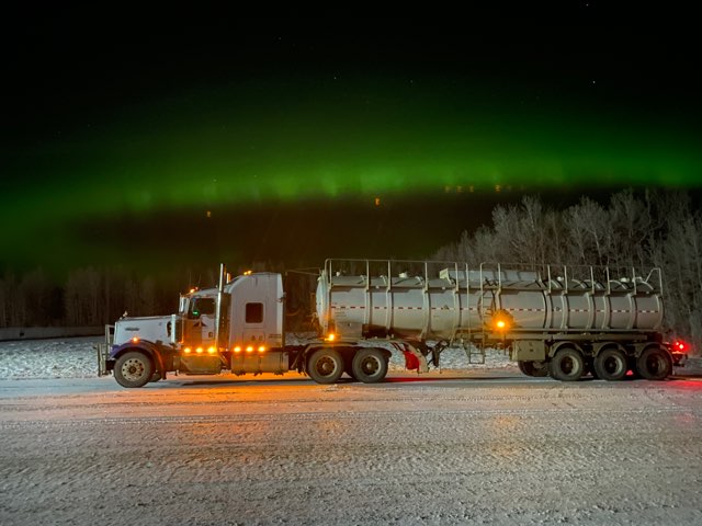 Truck under northern lights